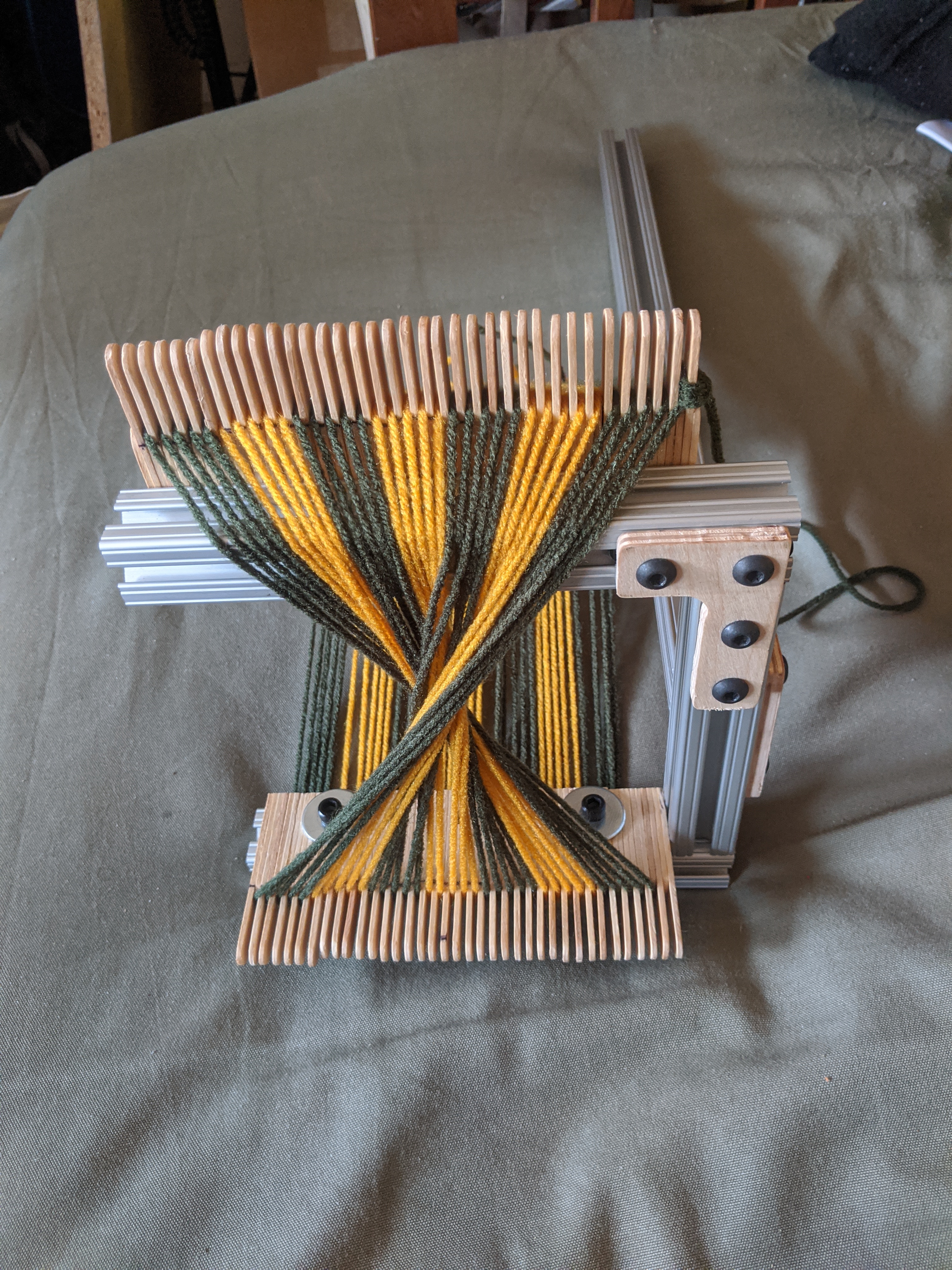 View showing warp threads twisting around each other
                between combs