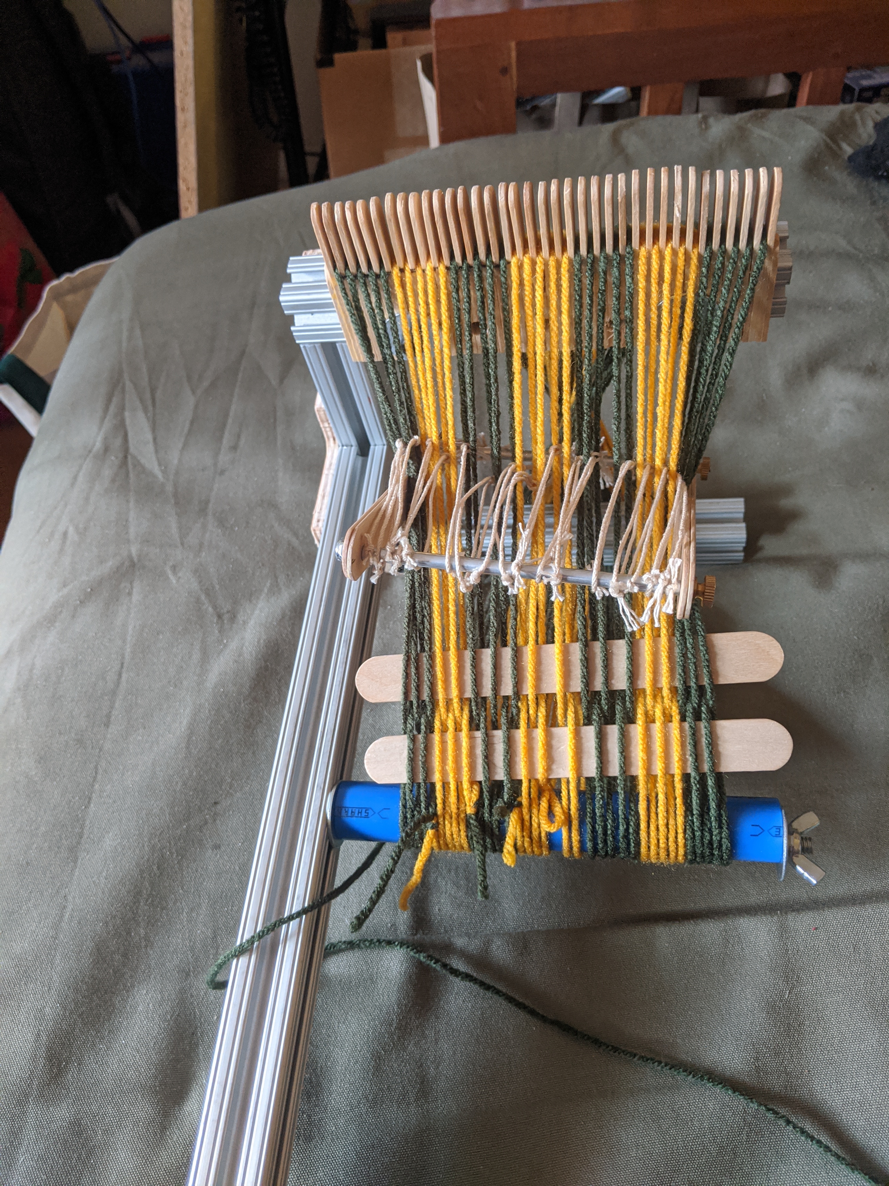 Start of weaving with two tongue depressors temporarily woven in